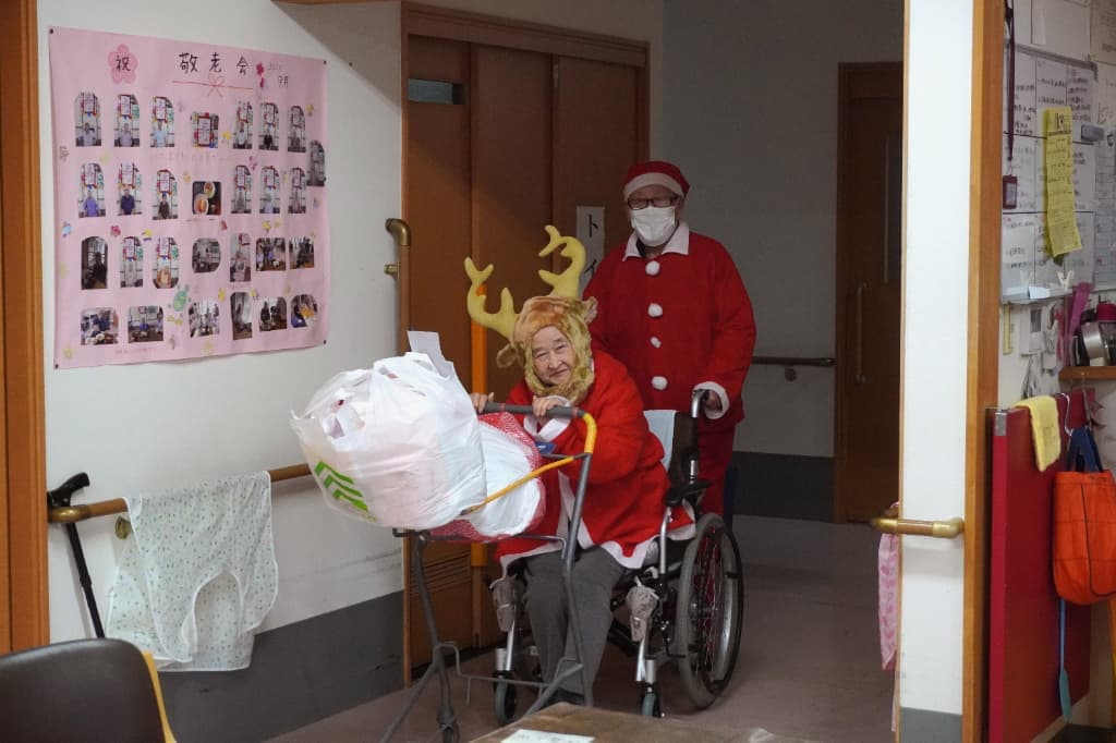 かわいいトナカイさんとかっこいいサンタさんになった入居者さんが、プレゼントを持って登場！